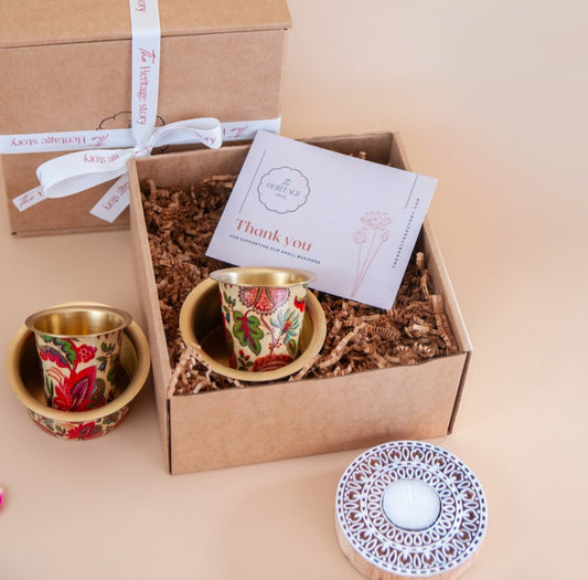 Gift box with south indian filter coffee set  and a woode blockprint tealight holder on a beige background
