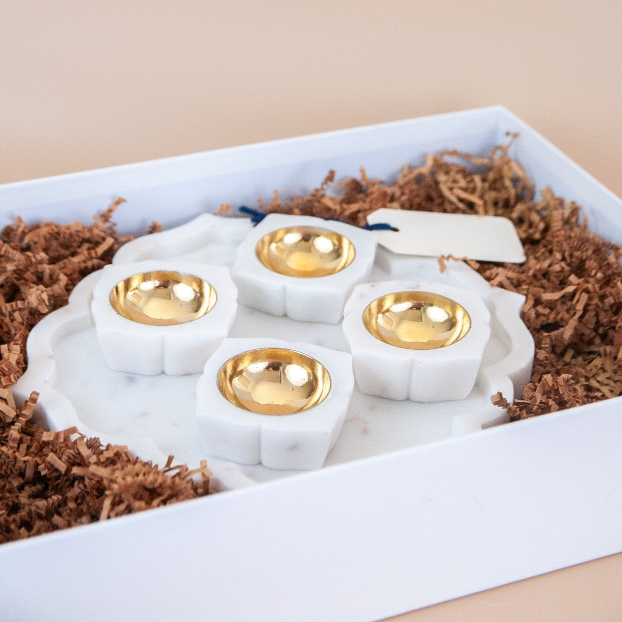 Marble platter with 4 marble and brass tealight holders in a white gift box.