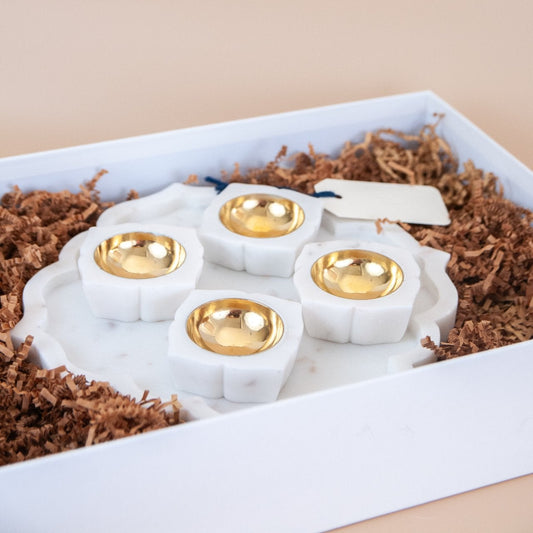 Marble platter with 4 marble and brass tealight holders in a white gift box.